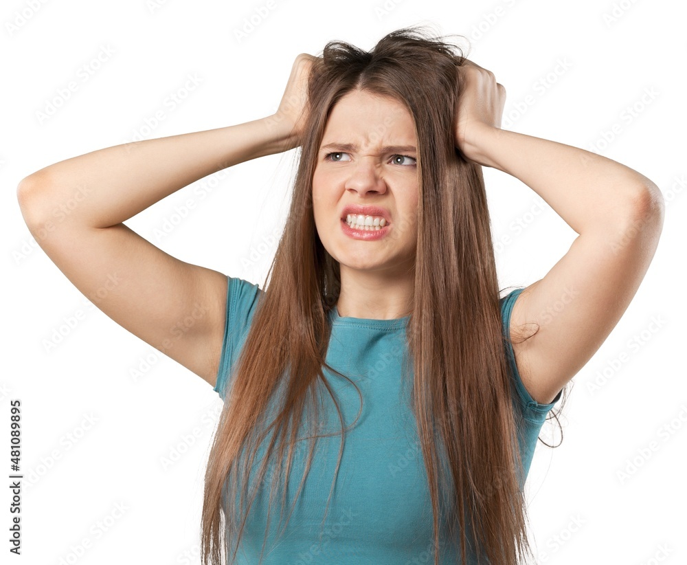 A frustrated and angry woman pulling her hair.