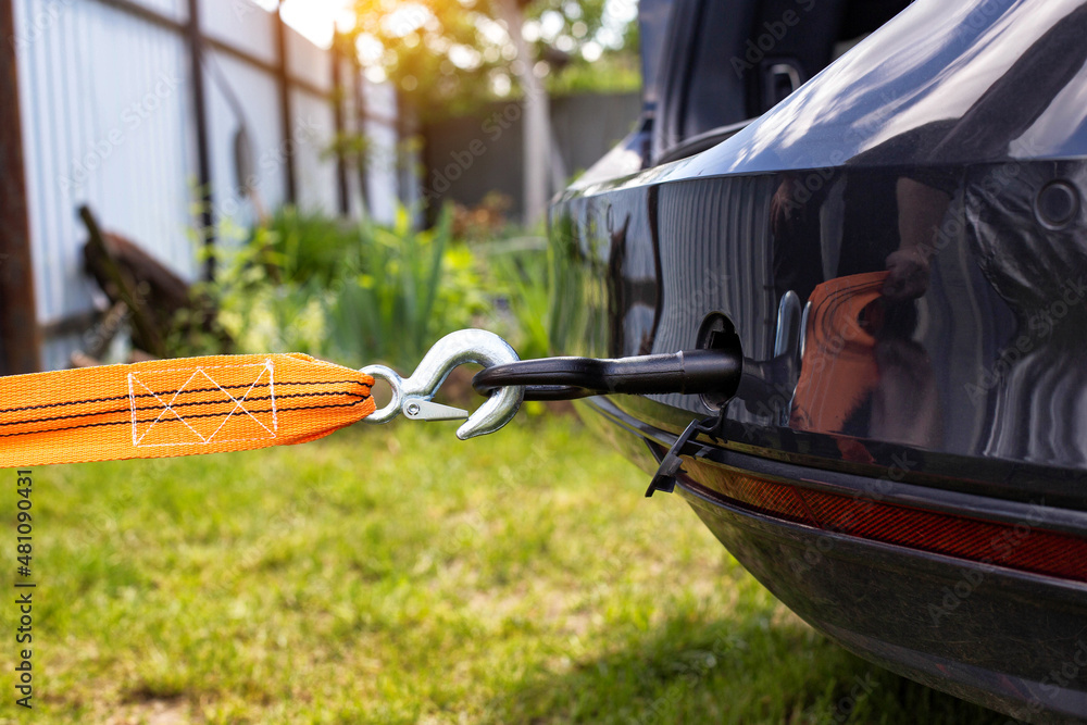 Φωτογραφία Screws in a tow hook in the car and an orange tow rope for towing, close-up, ind