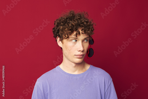 portrait of a young curly man hand gestures heart shaped glasses posing isolated background