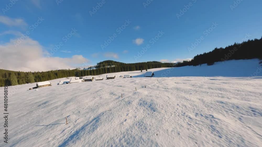 FPV drone shot captured in Slovenia in Pokljuka forest with surrounding nature and mountains at golden hour at sunset with fast and cinematic movement around the village and forest FPV drone shot captured in Slovenia in Pokljuka forest with surrounding nature and mountains at golden hour at sunset with fast and cinematic movement around the village and forest