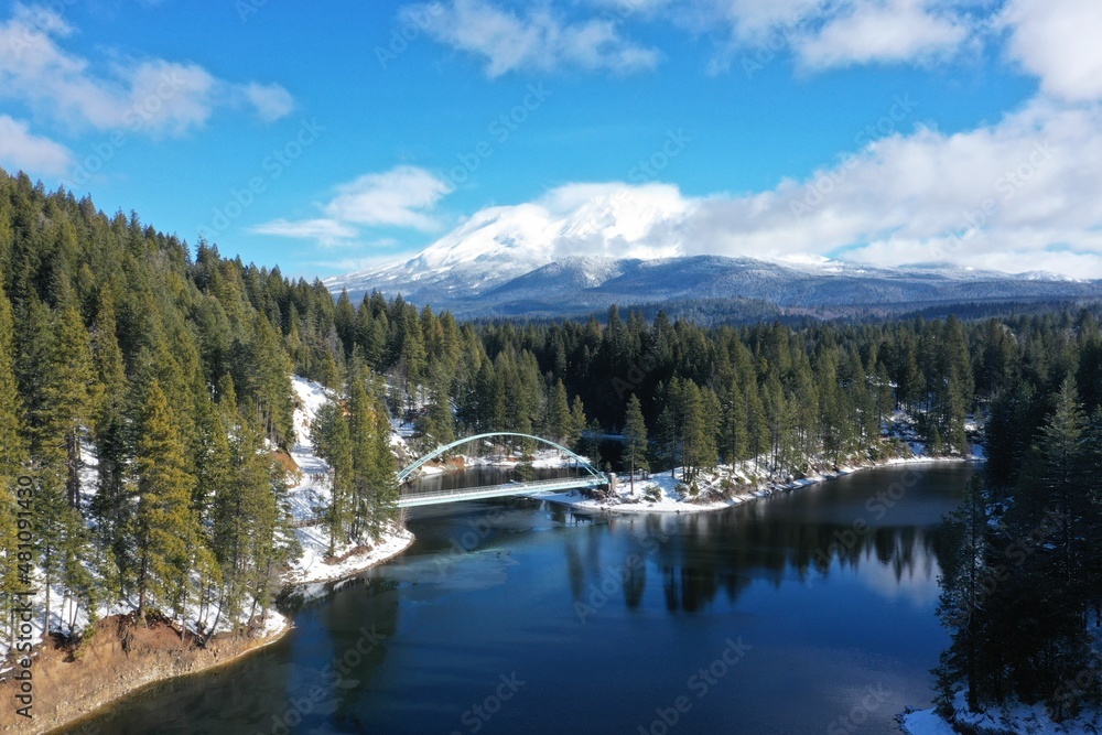 Lake with walking bridge with snow covered mountain in the background