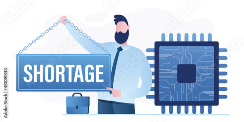 Semiconductor shortage. Big microchip. Businessman holds placard - shortage. Computer chip supply chain shortage due to Covid-19 pandemic, electronics manufacturing problem.