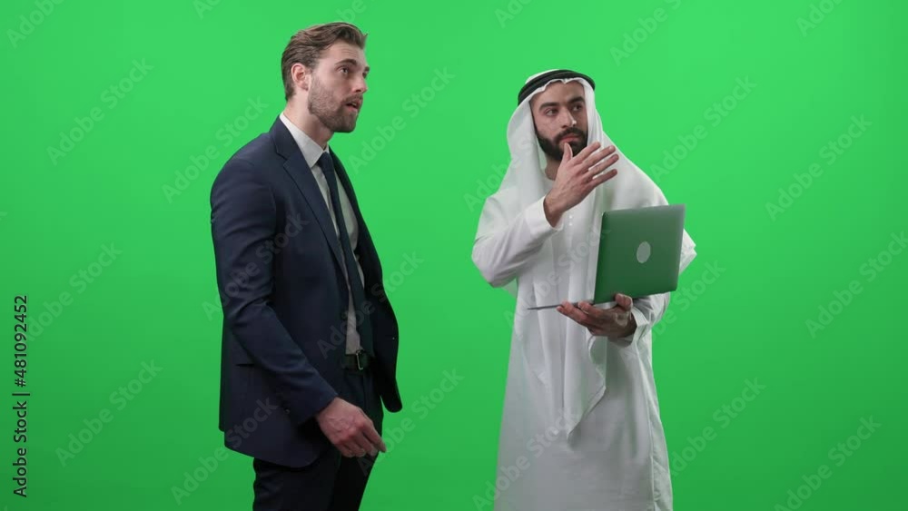 Arab man in a white kandura uses a laptop and communicates with a business partner, discussing investments, chroma key template. Arab man in a white kandura uses a laptop and communicates with a business partner, discussing investments, chroma key template.
