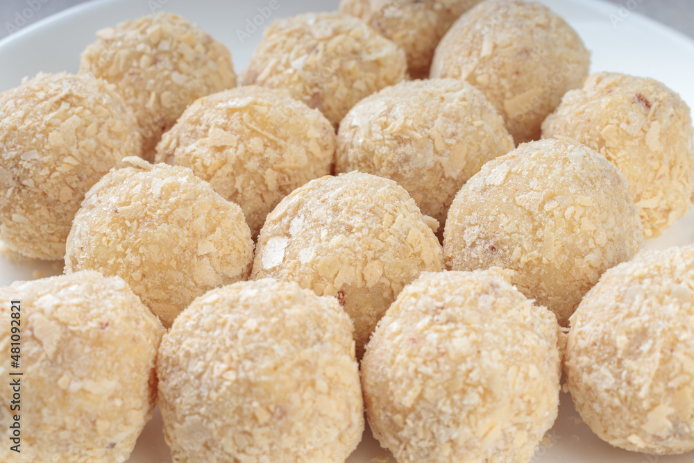 Close-up view of healthy raw paleo energy coconut balls. Soft focus.