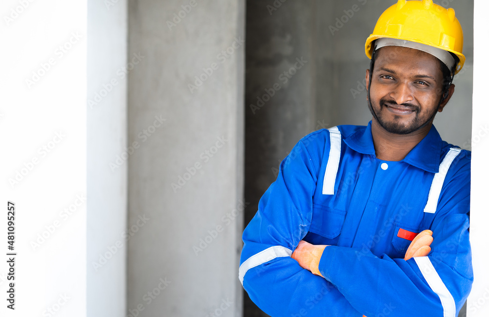 Portrait of smiling Plumber or handyman standing with crossed arms by loooking at camera with copy space -concept of successful professional occupation and ready for repair or maintenance service Portrait of smiling Plumber or handyman standing with crossed arms by loooking at camera with copy space -concept of successful professional occupation and ready for repair or maintenance service