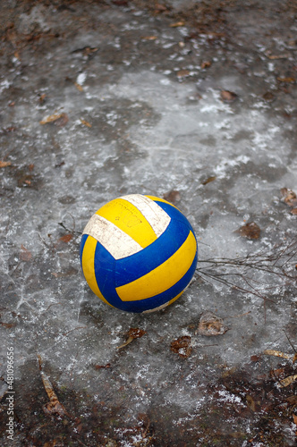 volleyball ball on an open-air sports field covered with frost photo
