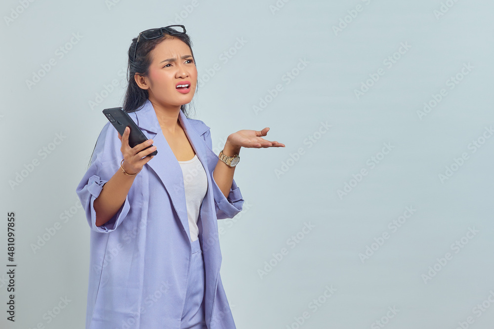 Portrait of surprised young Asian woman using mobile phone with open mouth isolated on white background Portrait of surprised young Asian woman using mobile phone with open mouth isolated on white background