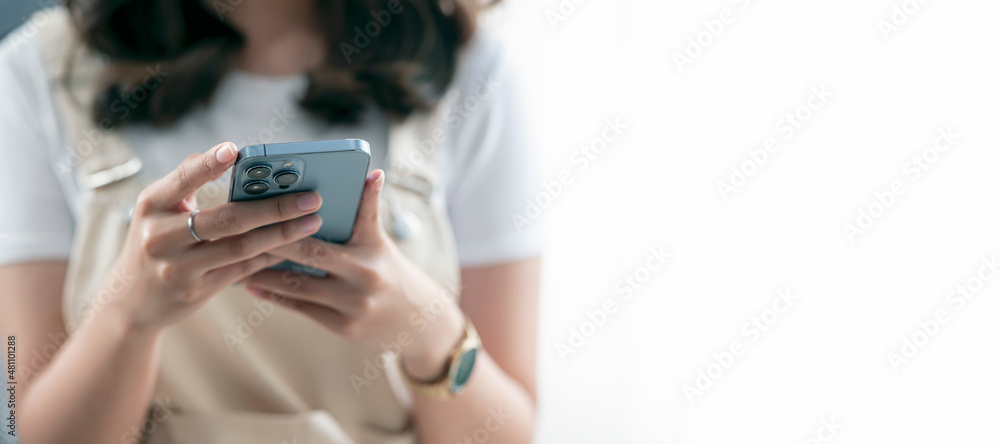 panoramic shot of caucasian woman using smartphone isolated on white background. Closeup view and copy space. panoramic shot of caucasian woman using smartphone isolated on white background. Closeup view and copy space.