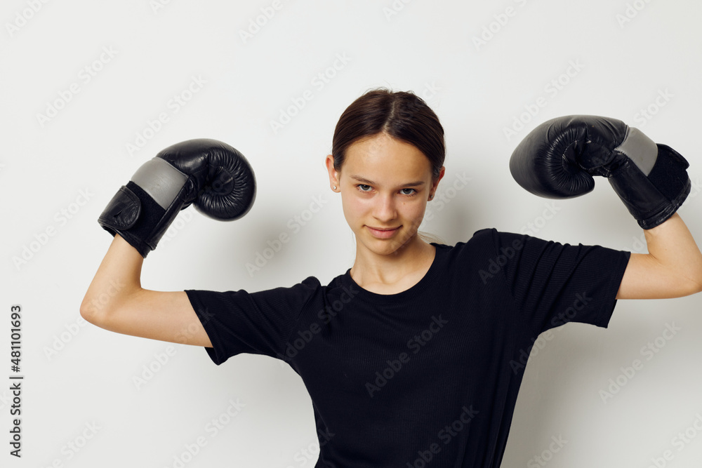 athletic woman in boxing gloves in black pants and a T-shirt fitness training athletic woman in boxing gloves in black pants and a T-shirt fitness training