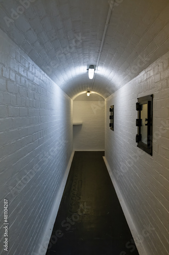 Narrow corridor with white bricks in old historic fortification