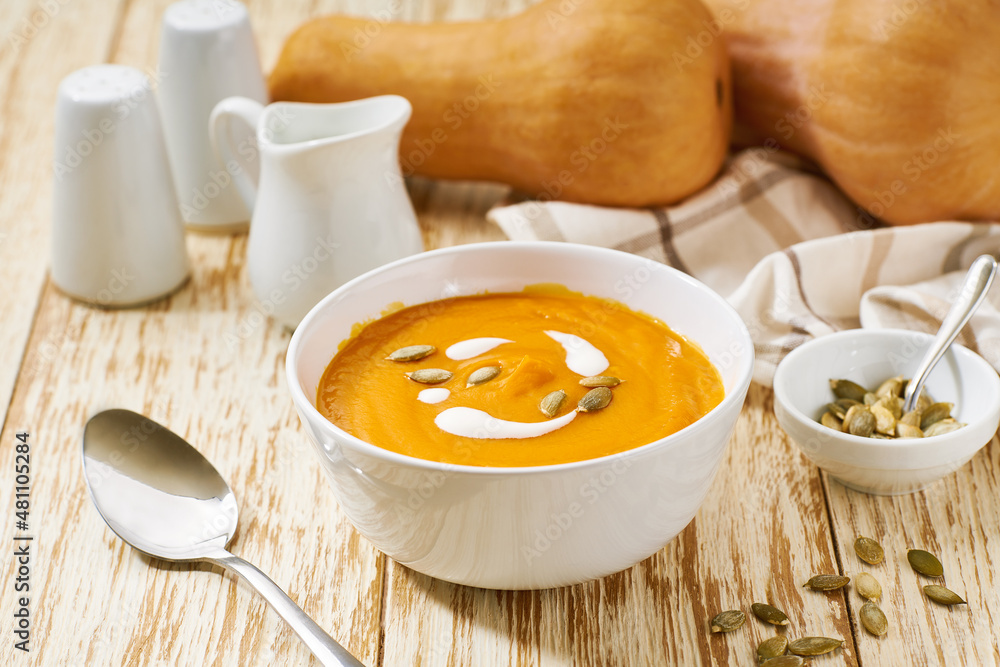 Bowl of homemade soup with organic butternut squash with cream sauce, selective focus. Bowl of homemade soup with organic butternut squash with cream sauce, selective focus.