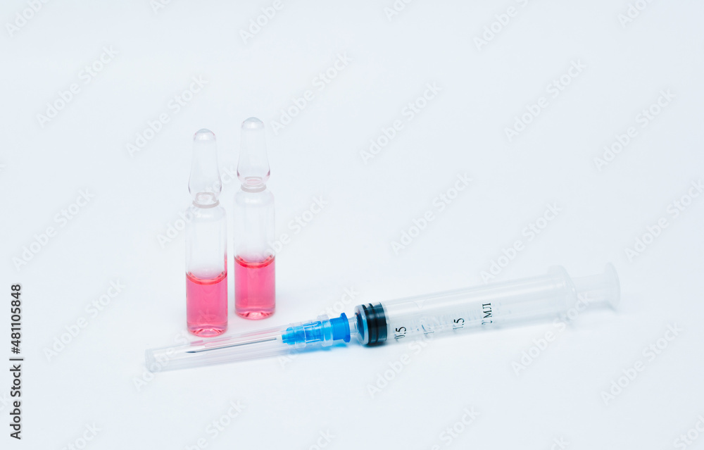 Medicinal or cosmetic ampoules jars of vaccines isolated on white background as a concept of cosmetology medicine and treatment with syringes injections. Medicinal or cosmetic ampoules jars of vaccines isolated on white background as a concept of cosmetology medicine and treatment with syringes injections.