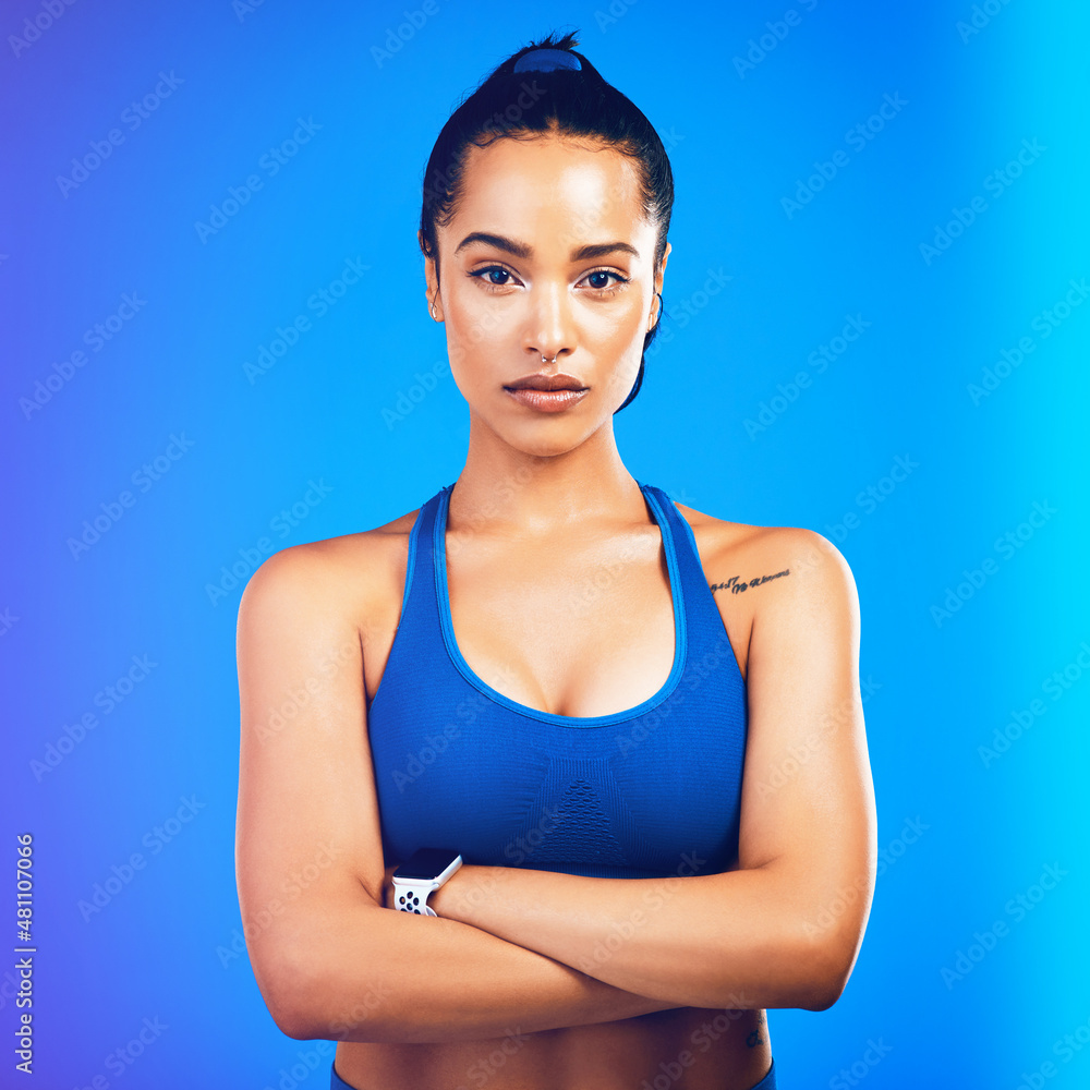 Fitness takes dedication. Studio portrait of an attractive young sportswoman posing against a blue background.