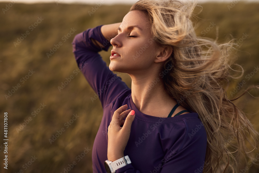 Woman with flying hair on windy day