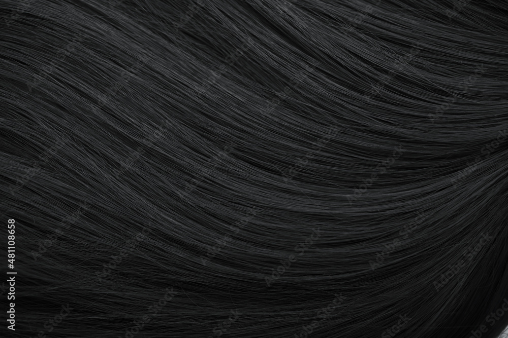 Naklejka premium Brunette or black hair. Female long dark hair in black. Beautifully laid curls. Closeup texture in a dark key. Hairdressing, hair care and coloring. Shading gray hair. Background with copy space.
