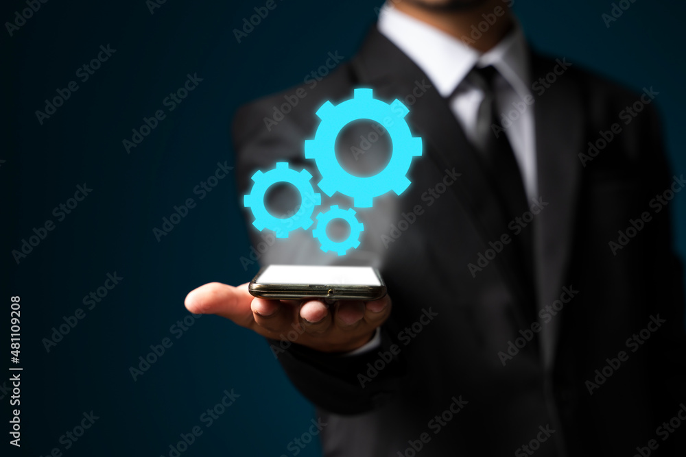 Image of businessman showing gear elements. Mechanism concept Image of businessman showing gear elements. Mechanism concept