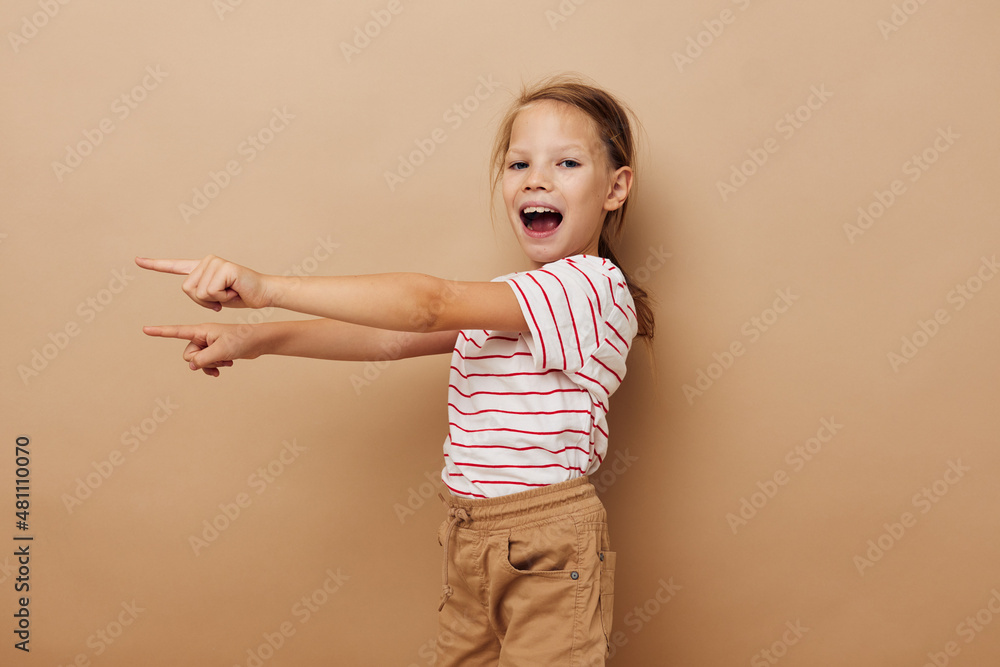 cheerful girl in a striped T-shirt gestures with her hands cheerful girl in a striped T-shirt gestures with her hands