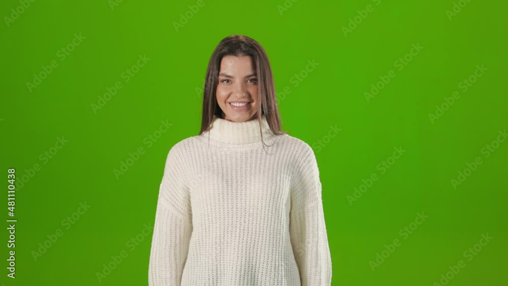 Portrait of caucasian young woman with dark hair, wearing white knitted sweater, smiling on camera. Good looking woman isolated over chroma key studio background. Portrait of caucasian young woman with dark hair, wearing white knitted sweater, smiling on camera. Good looking woman isolated over chroma key studio background.