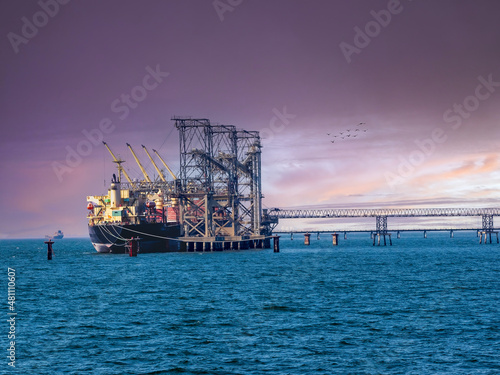 Bulk Vessel alongside at thailand port and loading bulk cargo by shiploader.