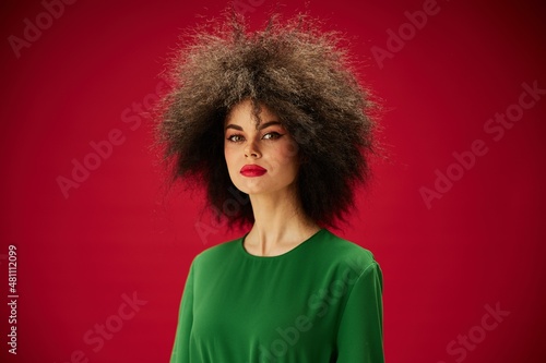 portrait of a woman in a green afro dress hairstyle close-up