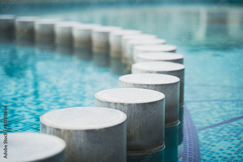 closeup of pool with decorative concrete pillars