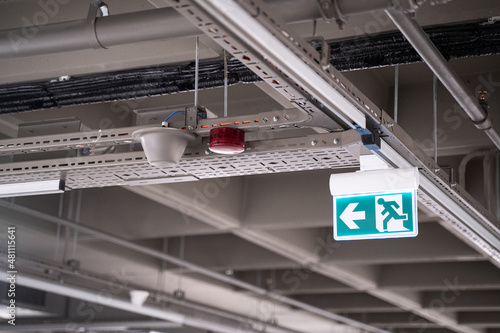 lighted green exit sign in an industrial building