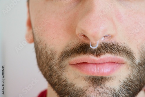 Man wearing anti snoring device into nose 