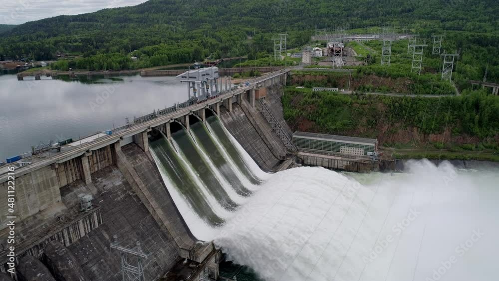 Aerial side view of water discharge at hydroelectric power plant Aerial side view of water discharge at hydroelectric power plant
