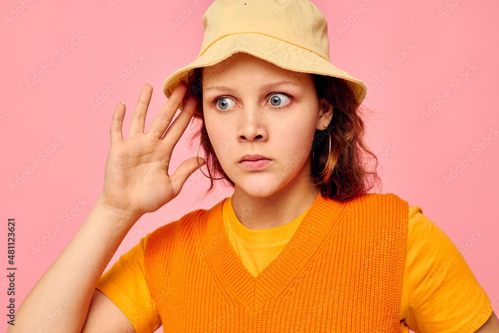 funny girl in an orange sweater in yellow hat hand gesture cropped view unaltered funny girl in an orange sweater in yellow hat hand gesture cropped view unaltered