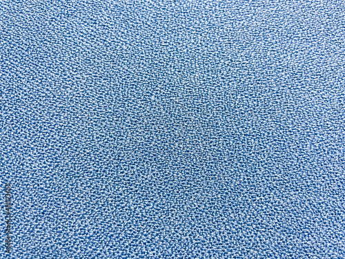 Close-up photo of blue rough fabric with distinctive texture.