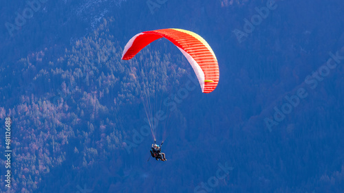Paragliding over Swiss lake and mountains in Interlaken in Switzerland