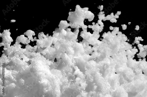 White soap foam on a black background. Fun foam, background or texture of white foam with copy space. Entertaining foam parties of the summer entertainment festival in the water park.