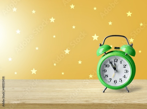 Alarm clock on yellow background. Christmas and Happy new year concept.