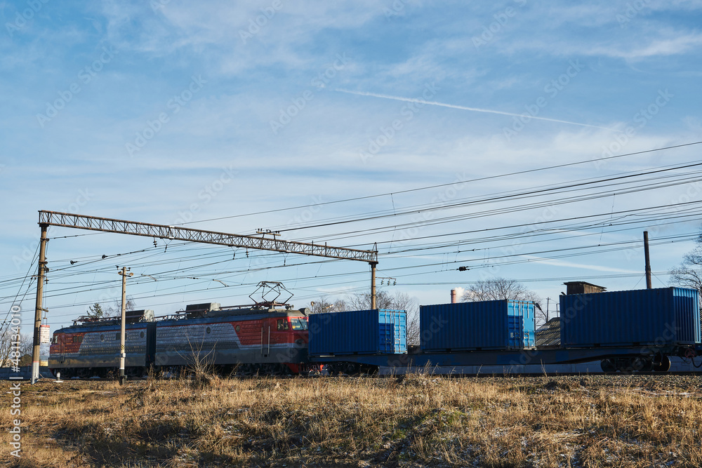 train locomotive dragging blue containers on platforms train locomotive dragging blue containers on platforms