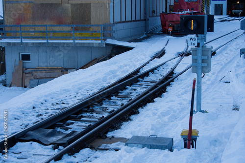 Empty railway tracks with railway switch of Lauterbrunnen Mürren Mountain Railway on a sunny winter day. Photo taken Januaray 15th, 2022 Lauterbrunnen, Switzerland. photo