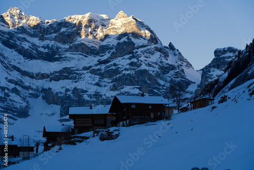 Mountain panorama at the Swiss Alps with chalets in the foreground on a winter morning seen from mountain village Gimmelwald. Photo taken January 15th, 2022, Lauterbrunnen, Switzerland.