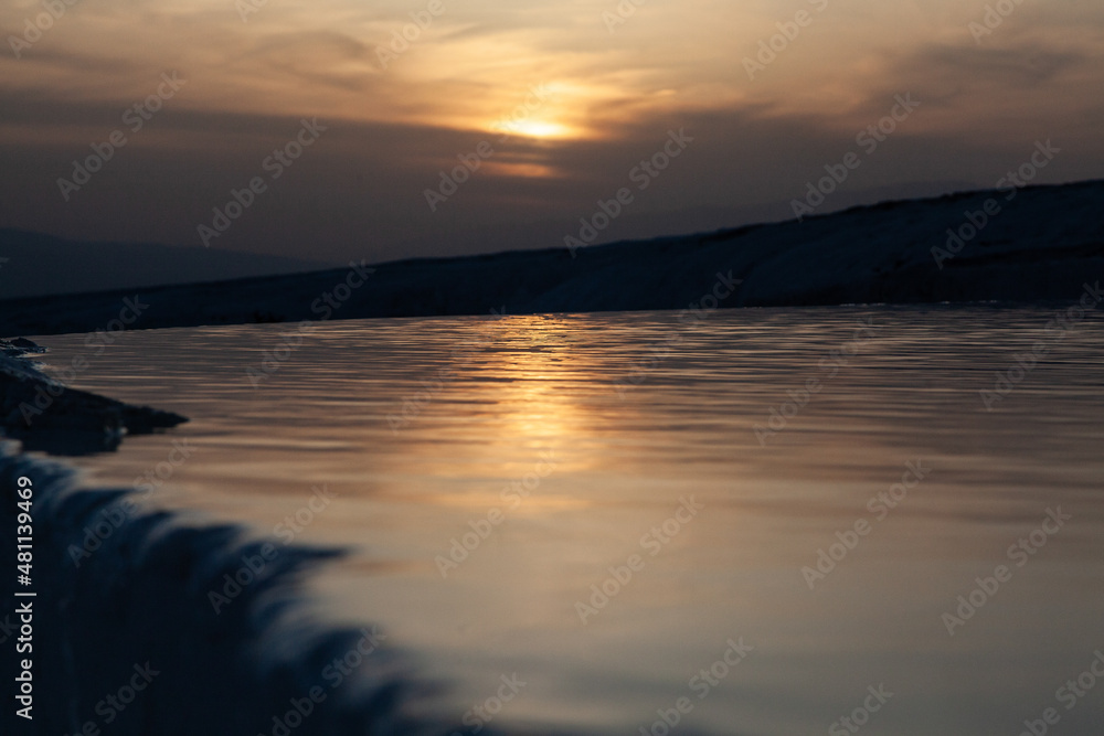 Fototapeta premium Sunset reflection on travertine in close-up view, Pamukkale, Turkey