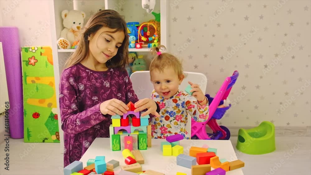 The child plays with toys in the room. Selective focus. The child plays with toys in the room. Selective focus.