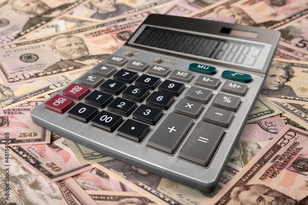 Money banknotes on a wooden table with a calculator Economics and financial planning Money banknotes on a wooden table with a calculator Economics and financial planning