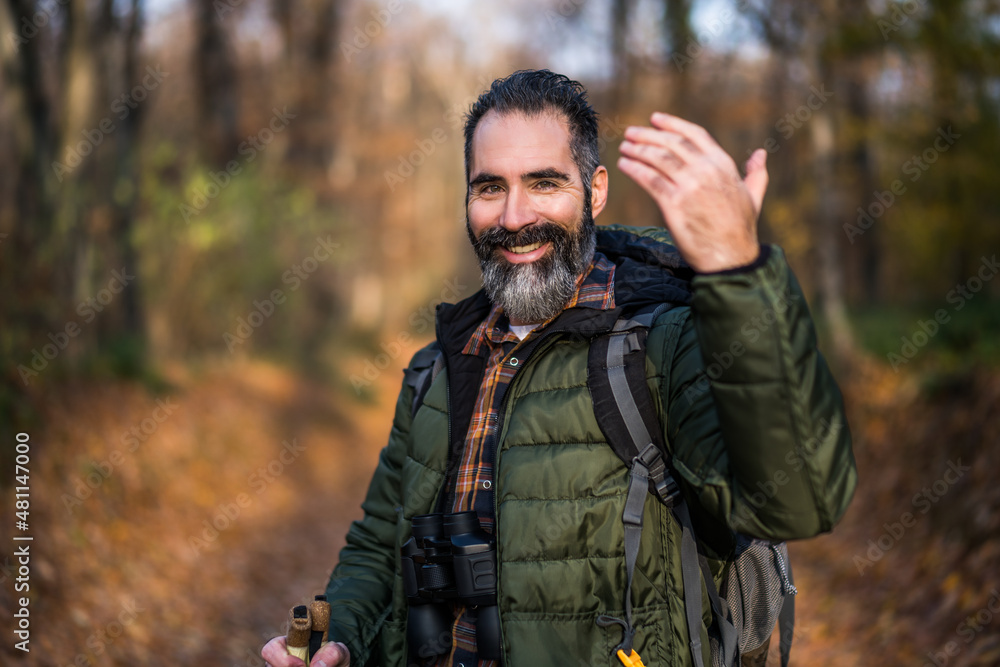 Image of hiker showing invitation gesture while hiking in nature.