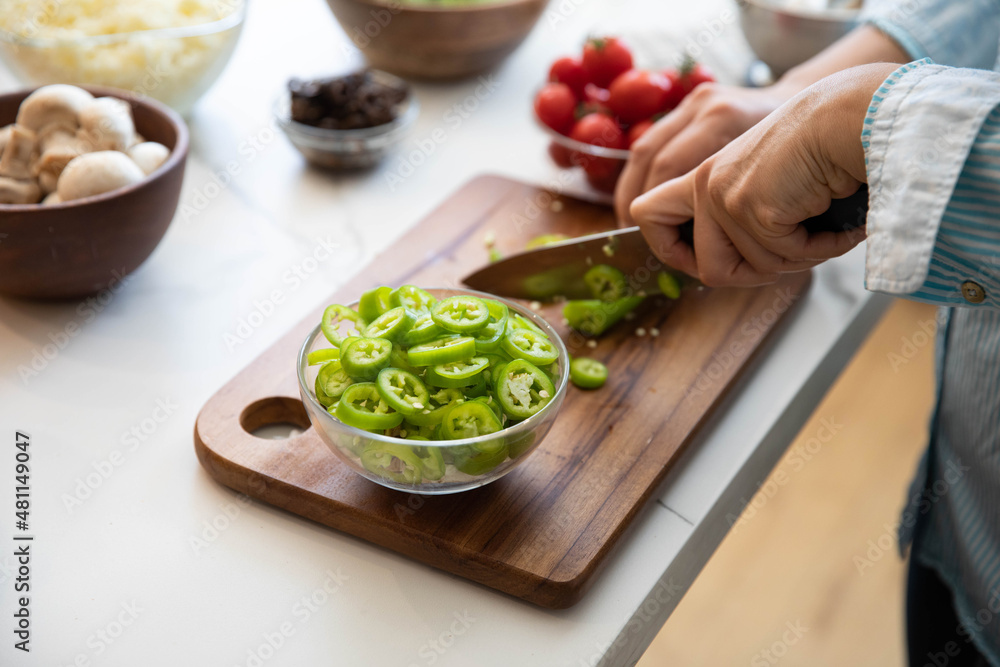 Pepper cutting, woman chopping pepper on cutting board Pepper cutting, woman chopping pepper on cutting board