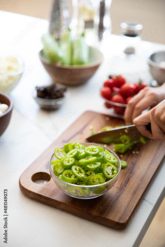 Pepper cutting, woman chopping pepper on cutting board Pepper cutting, woman chopping pepper on cutting board