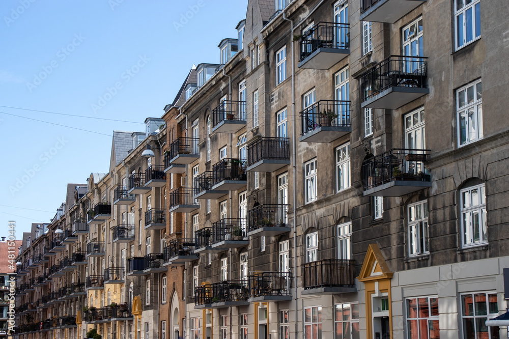 Fototapeta premium Copenhagen, Denmark-Christianshavn canal, colorful facades of old houses. King Christian's Harbour is a neighbourhood in Copenhagen. Real estate investment. Rent an apartment. Expensive housing. 