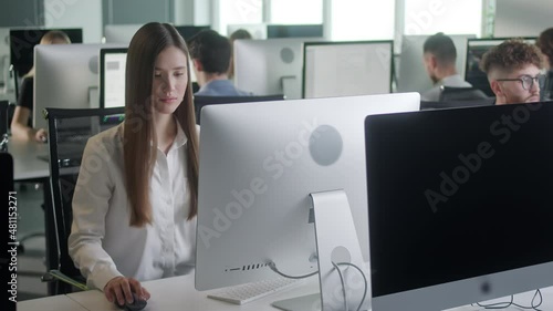 Professional Creative Businesswoman Working on Decktop Computer in Open Space Office . Female Professional Typing on PC Keyboard at Office Workplace. Portrait of Positive Business Girl Looking at photo