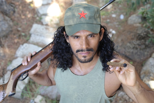 Guerrilla fighter with weapon and cigar photo