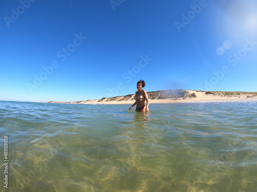 Attractive brunette woman bathing in the sea