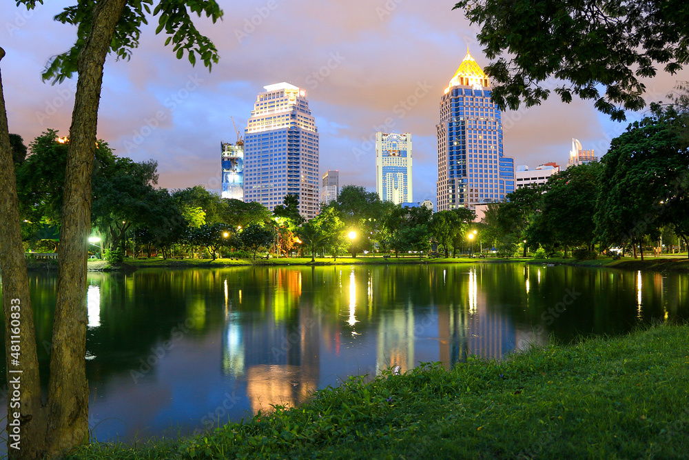 Lumphini Park, Bangkok, Thailand. View of modern buildings from the beautiful park in the center of the city.
