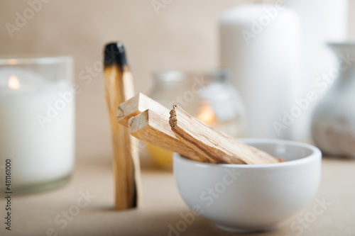 Palo Santo bars close-up and copy space. Ritual cleansing with sacred ibiocai, meditation, aromatherapy with incense and candles..