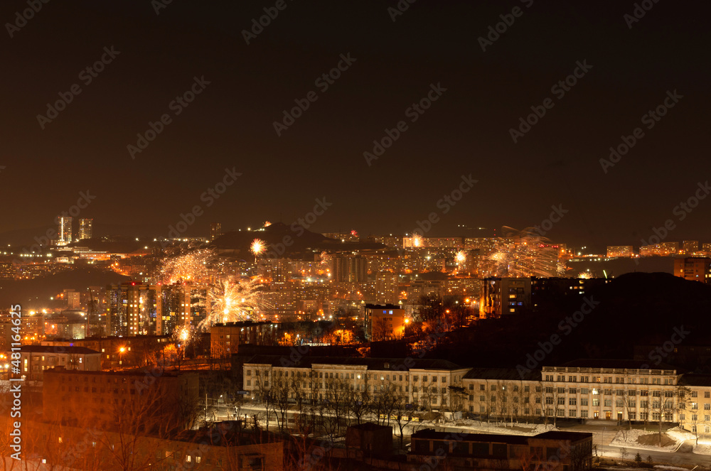 Fototapeta premium Fireworks in the city at night during New Year celebration. Soft focus background