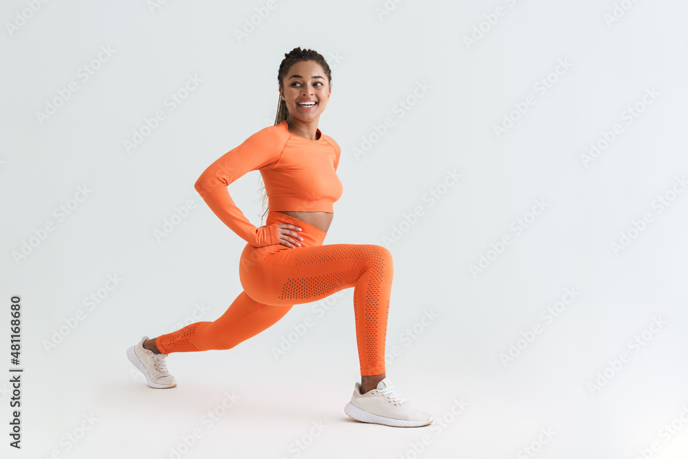 Black young sportswoman doing exercise while working out